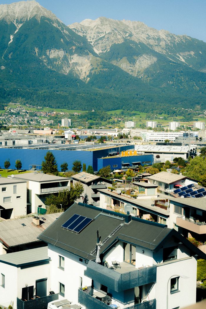 services-04 Stunning aerial view of Innsbruck, Austria, showcasing modern and traditional architecture against the majestic Alps.