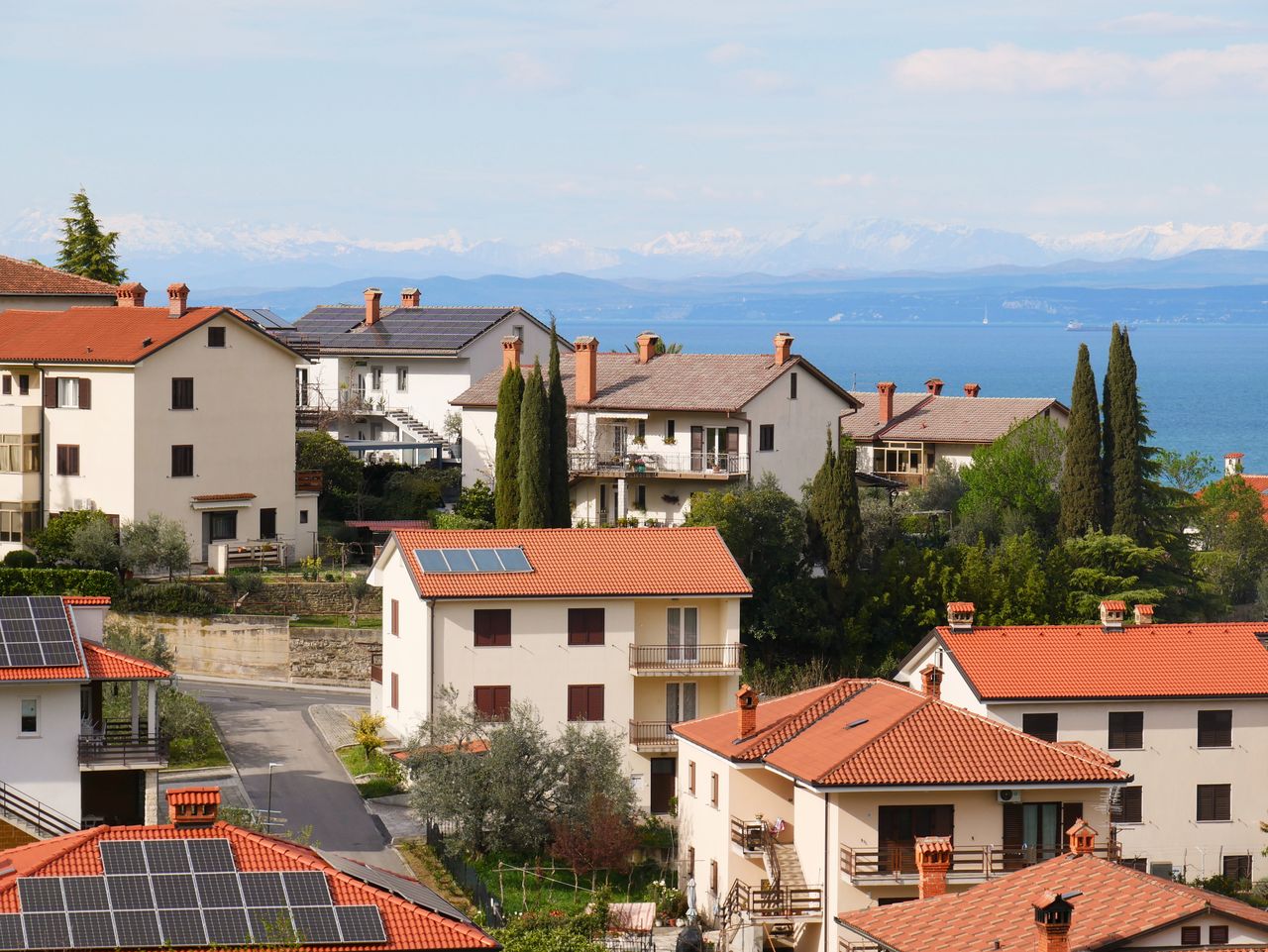services-01 Picturesque Mediterranean village with red-tiled roofs and sea view, showcasing serene coastal living.